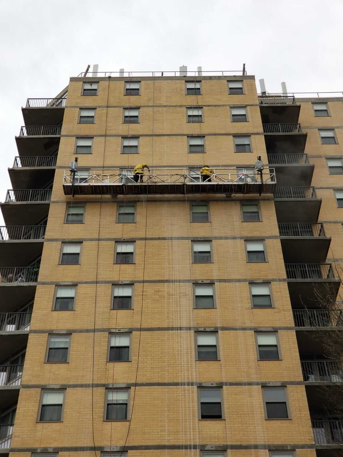 Presto waterproofing technicians using swing stage on B’nai B’rith Apartments, Allentown, PA