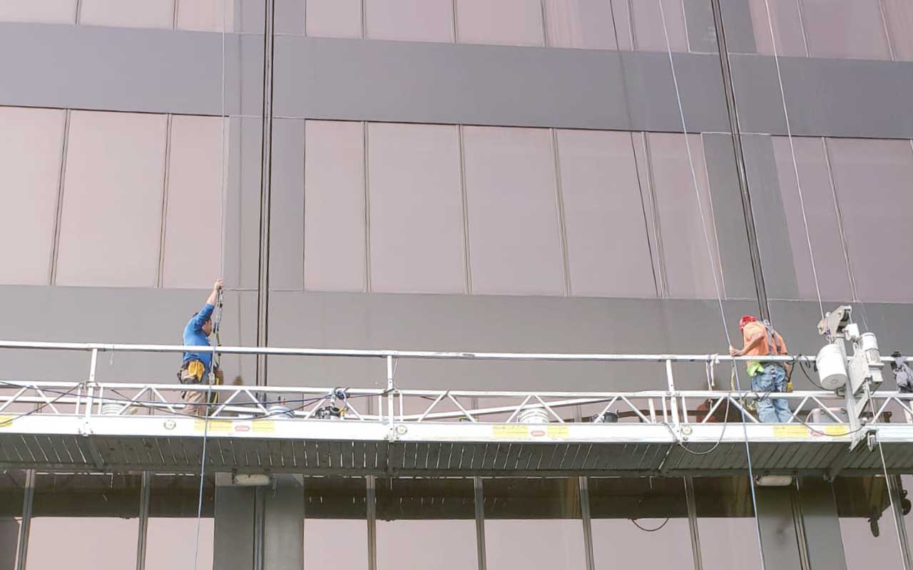 Best Commercial Waterproofing Services in process on glass and metal building